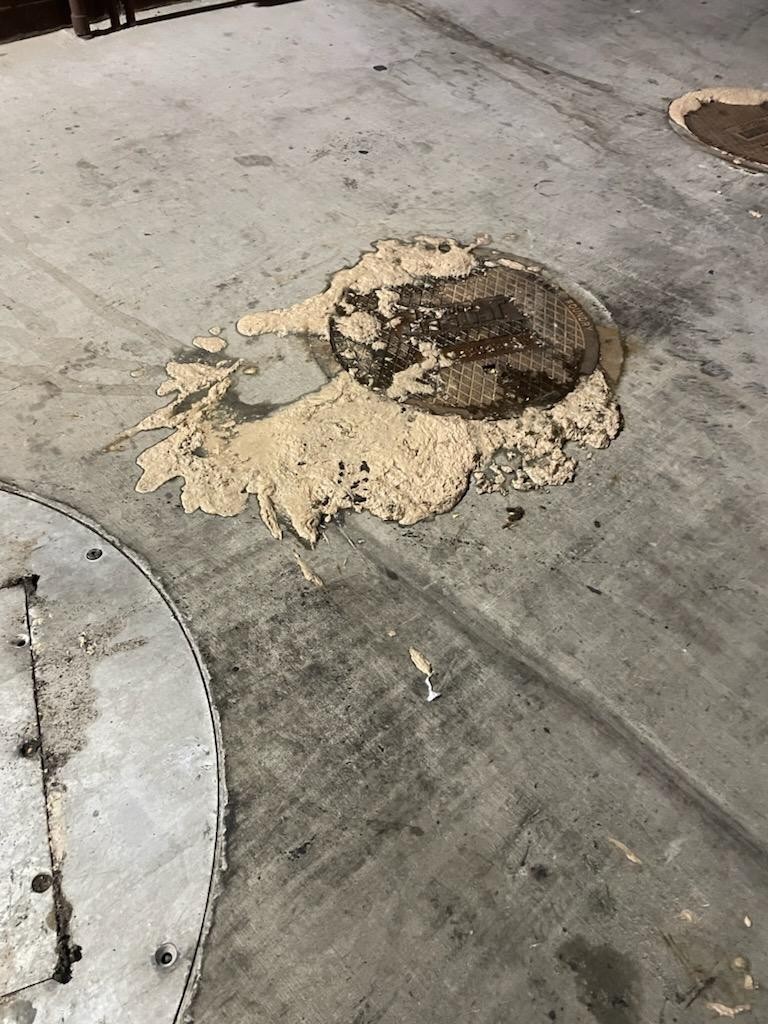 Grease overflowing from a kitchen floor sink before emergency service in Eastvale, California